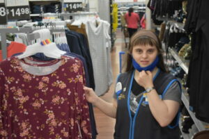 A women working in the clothing section of Walmart.